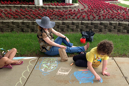 Child Drawing on Sidewalk